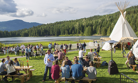 Incentive travel participants enjoying their trip near a lake and forest